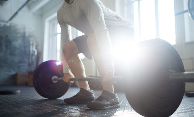 The deadlift setup with a double-overhand grip. Which grip you use changes how the exercise affects your musculature.