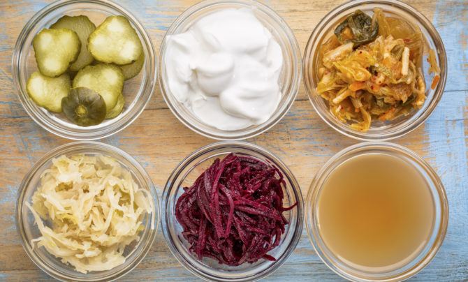 Six foods good for gut health, including pickles, yogurt, kimchi, sauerkraut.