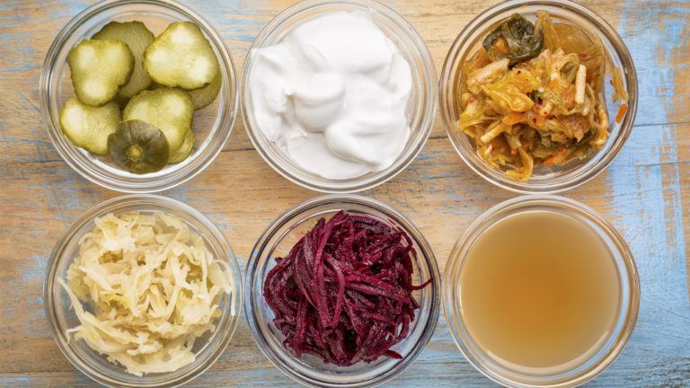 Six foods good for gut health, including pickles, yogurt, kimchi, sauerkraut.