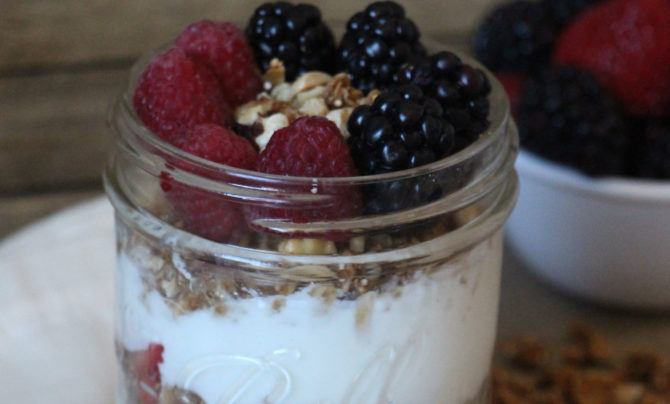 Raspberries and blackberries atop a healthy yogurt parfait.