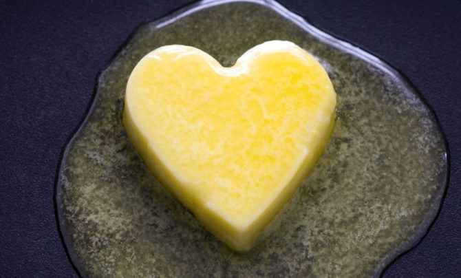 Plenty of saturated fat here: A heart shaped pat of yellow butter melts.