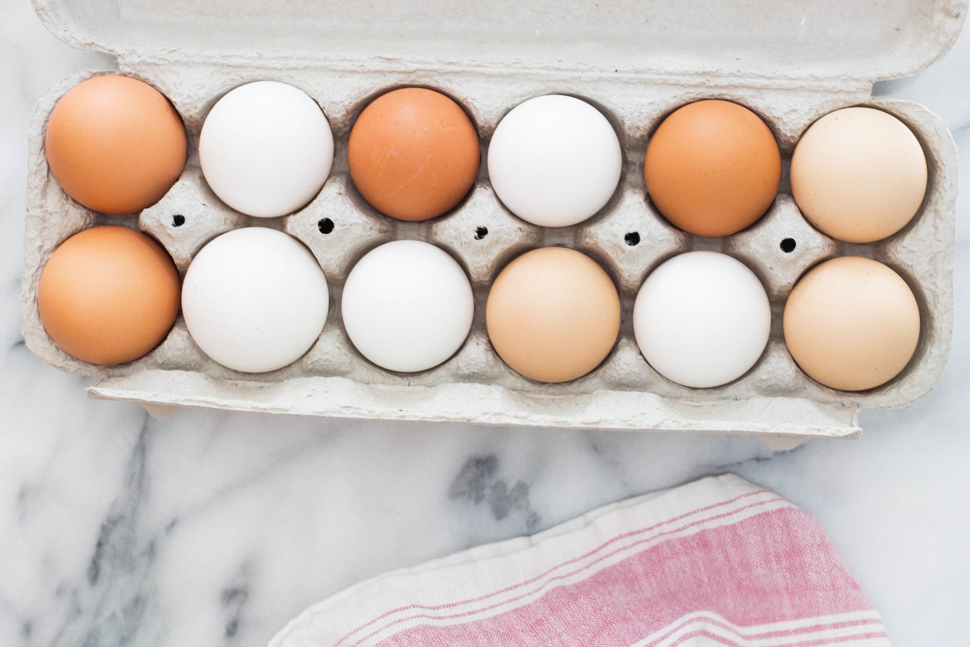 a carton of multi-colored eggs