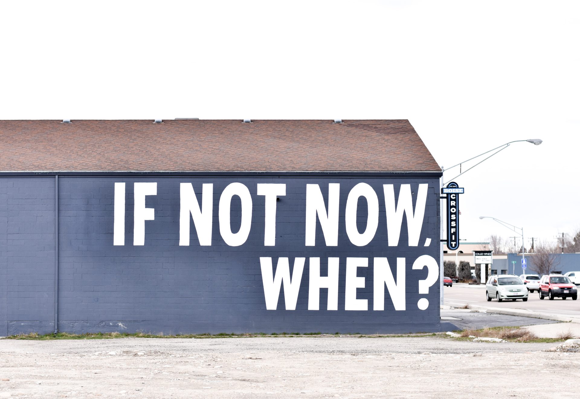 blue building with "if not now, when?" painted on the side