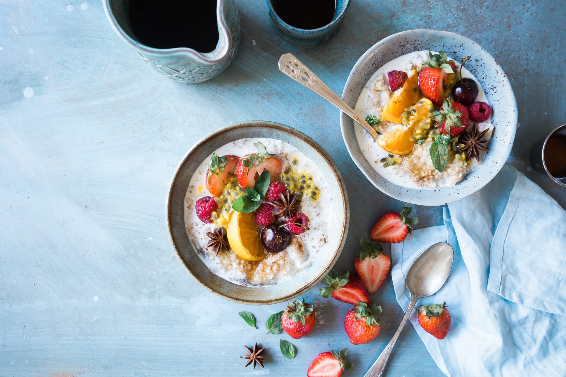 2 bowls of oatmeal topped with fruit