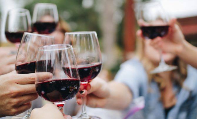 Red wine glasses coming together for a cheers