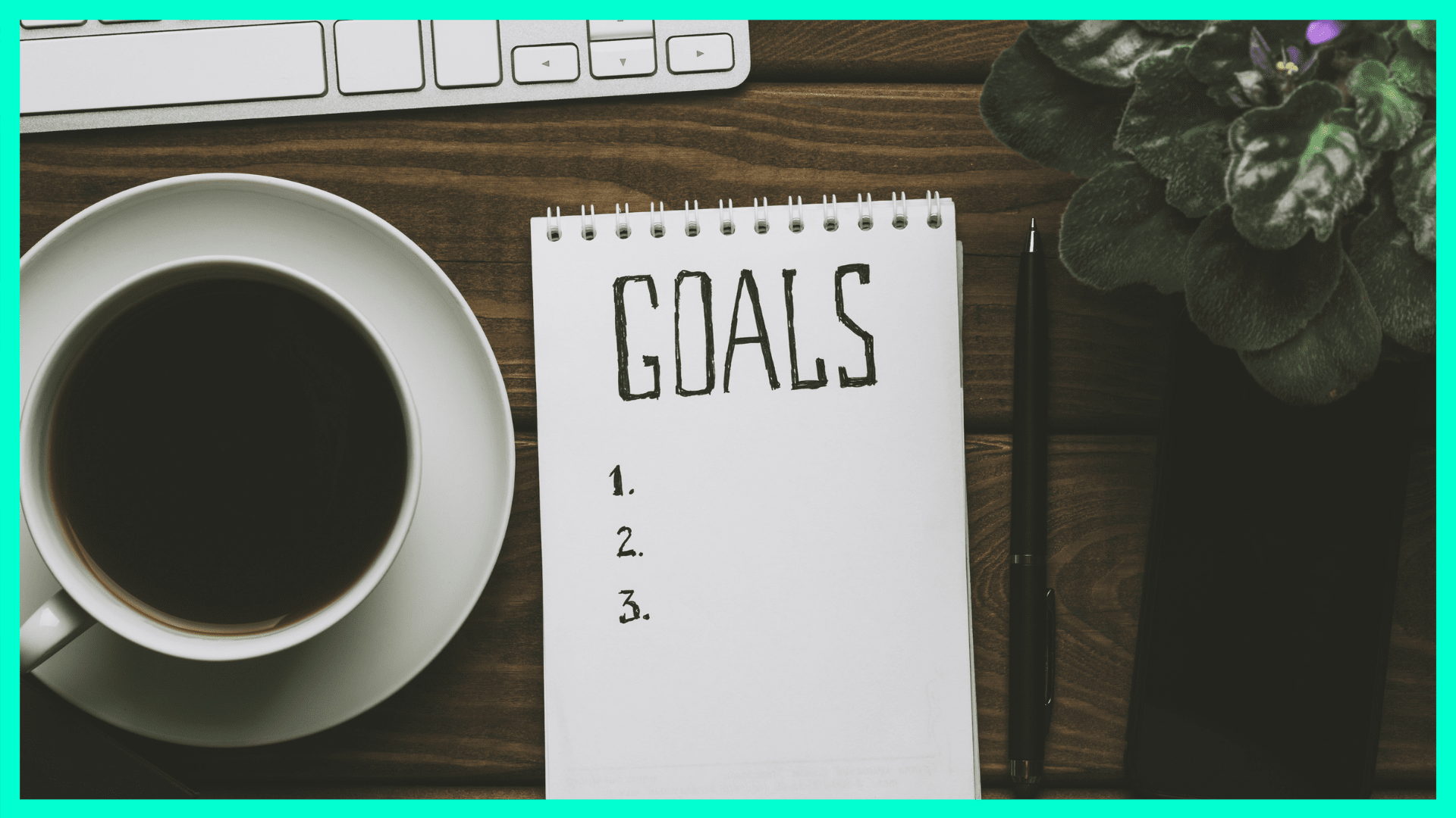 a notepad that says "goals" next to a cup of coffee