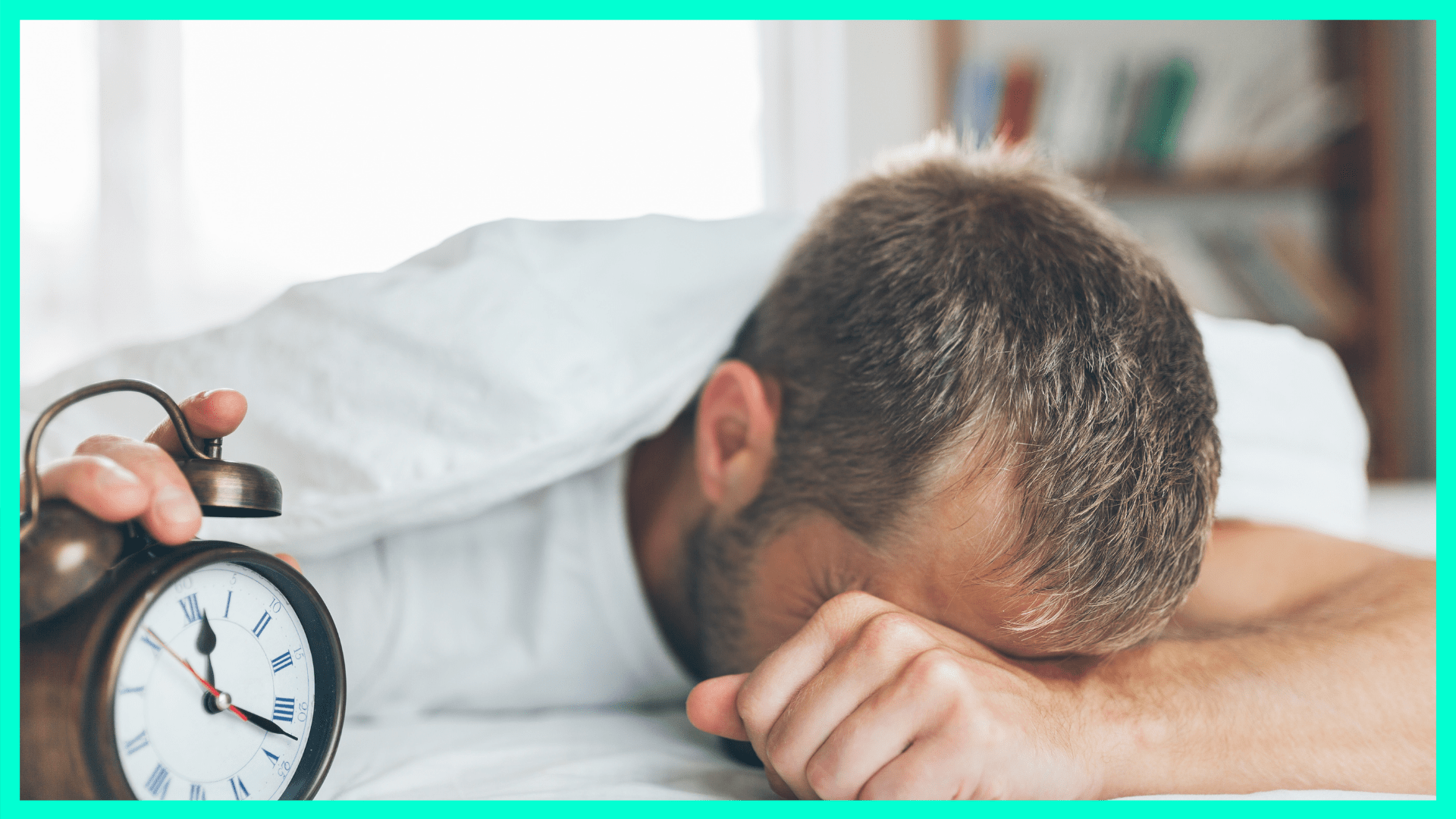 tired man shutting off alarm clock