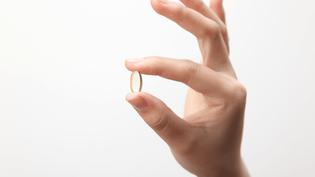 pill held between fingers