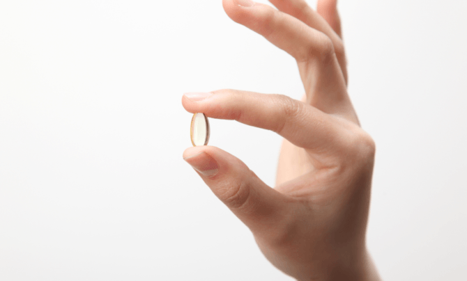 pill held between fingers