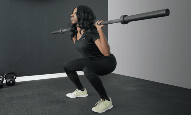 woman squatting with barbell